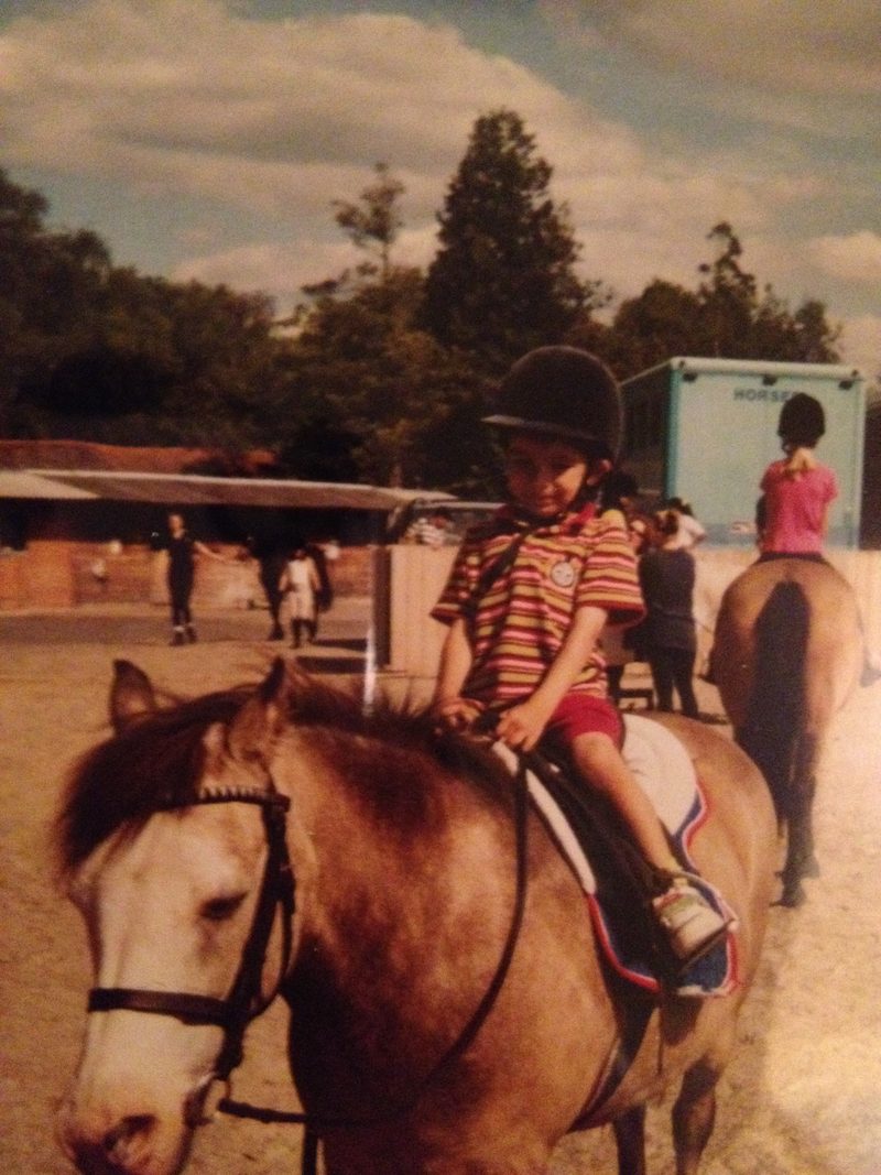 Usman as a young boy riding a pony